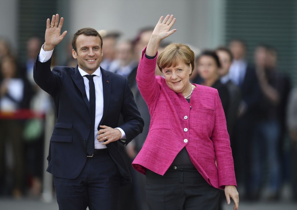 El nuevo presidente francés, Emmanuel Macron, saluda con la canciller alemana, Angela Merkel, a periodistas en la cancillería de Berlín, el 15 de mayo de 2017. (Bernd von Jutrczenka / dpa vía AP)