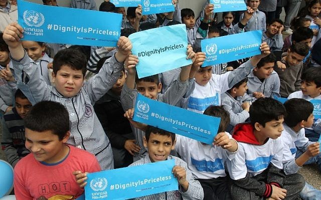 Los  llamados refugiados palestinos sostienen pancartas en una escuela perteneciente a la Agencia de Obras Públicas y Socorro de las Naciones Unidas para los Refugiados Palestinos (UNRWA) en la ciudad de Sebline al este del puerto libanés sur de Saida, el 12 de marzo de 2018, durante una protesta contra los recortes de ayuda de Estados Unidos a la organización. (AFP PHOTO / Mahmoud ZAYYAT)