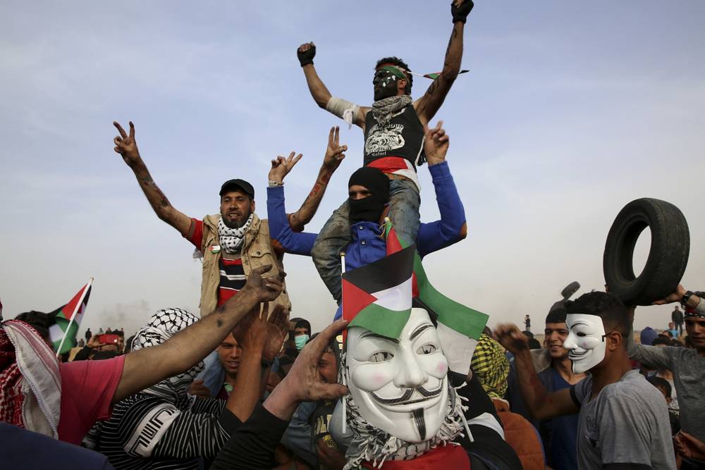 Atacantes islamistas palestinos corean amenazas frente a la frontera de Gaza con Israel, al este de Khan Younis, en la Franja de Gaza, el jueves 5 de abril de 2018. (AP Photo / Adel Hana)