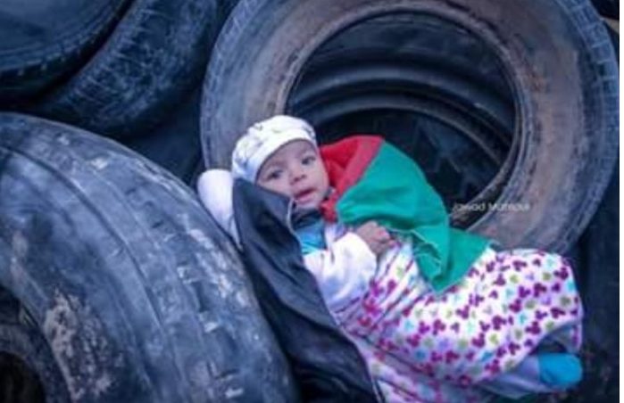 Niño árabe entre los neumáticos llevados por los islamistas, para quemarlos en la frontera con Israel. Crédito: MEMRI
