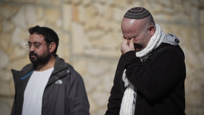 Amigos y parientes vistos de luto durante la ceremonia fúnebre de las cuatro víctimas judías de un ataque terrorista en París, que se celebró en el cementerio de Har HaMenuchot en Jerusalén, el 13 de enero de 2015. (Crédito de la foto: Yonatan Sindel / Flash 90)