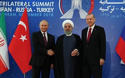 Una foto impresa tomada y publicada el 7 de septiembre de 2018 por el servicio de Prensa Presidencial de Turquía muestra al presidente turco Recep Tayyip Erdogan (R), al presidente iraní Hassan Rouhani (C) y al presidente ruso Vladimir Putin (L) uniéndose en una cumbre trilateral en Teherán . (Oficina de prensa de la Presidencia turca / AFP)