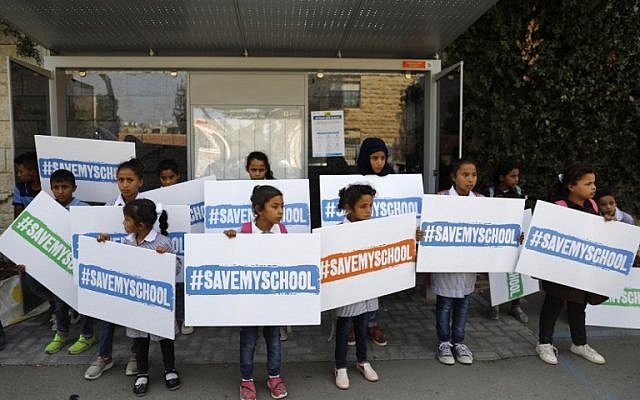 Los niños de la aldea beduina de Khan Al Ahmar, en la Ribera Occidental, llevan carteles con el eslogan "Salven mi escuela" mientras protestan frente a la residencia del presidente Reuven Rivlin en Jerusalén durante su reunión del 4 de octubre de 2018 con la canciller alemana, Angela Merkel, que llegó la noche anterior. en una visita oficial a Israel. (AFP PHOTO / Ahmad GHARABLI)