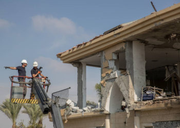 Las fuerzas de seguridad israelíes inspeccionan un edificio que fue alcanzado por un cohete disparado desde la Franja de Gaza en la ciudad de Beersheba, sur de Israel, el 17 de octubre de 2018. (Yonatan Sindel / Flash90)