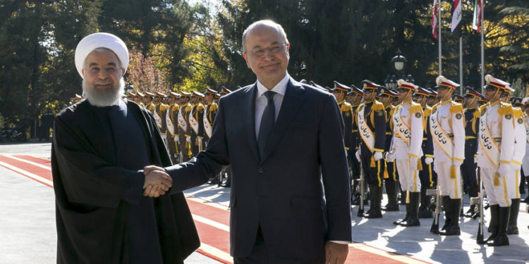 El presidente iraquí Barham Salih, a la derecha, y su homólogo iraní, Hassan Rouhani, se dan la mano durante una ceremonia oficial de bienvenida para Salih en el Palacio Saadabad en Teherán, Irán, el sábado 17 de noviembre de 2018. (Oficina de la Presidencia iraní a través de AP)