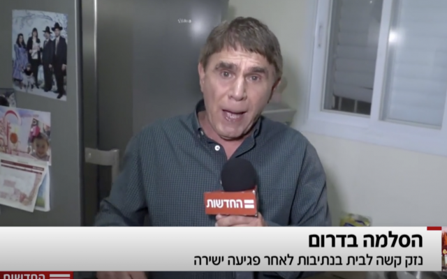 El reportero de Hadashot TV Moshe Nussbaum en una casa en Netivot golpeada por un trozo de metralla de un cohete de Hamás, 12 de noviembre de 2018 (noticias de Hadashot TV)