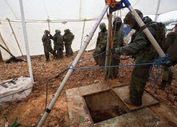 Soldados israelíes parados alrededor de la apertura de un hoyo que conduce a un túnel que fue excavado por el grupo terrorista Hezbolá a través de la frontera entre Israel y el Líbano, cerca de Metulla, el 19 de diciembre de 2018. (AP Photo / Sebastian Scheiner)