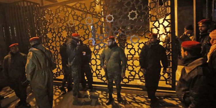 Las fuerzas de seguridad palestinas leales a Hamas (R) montan guardia fuera del cruce fronterizo de Rafah con Egipto, minutos antes de que la Autoridad Palestina retire a su personal (L) del cruce fronterizo de Rafah con Egipto el 7 de enero de 2019. (Foto de SAID KHATIB / AFP )