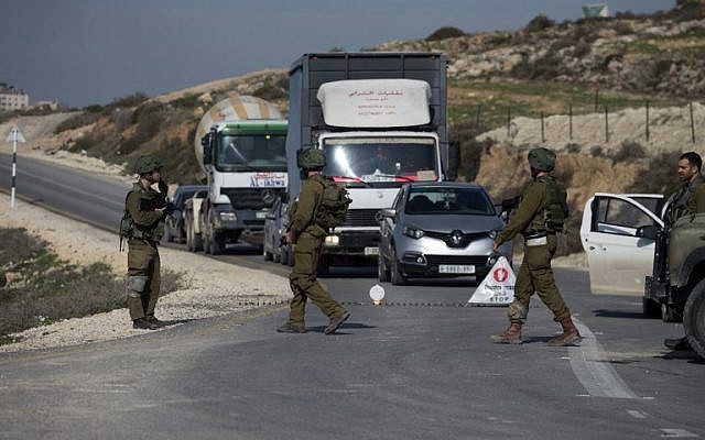 Ilustrativo: los soldados israelíes inspeccionan automóviles en un punto de control cerca de la ciudad de Nablus en Cisjordania el 10 de enero de 2018. (Jaafar / Ashtiyeh / AFP)
