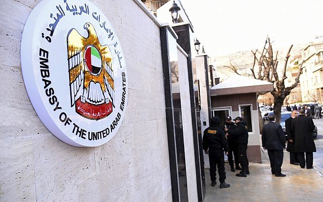 Funcionarios y periodistas se reúnen fuera de la embajada de los Emiratos Árabes Unidos, en Damasco, Siria, el 27 de diciembre de 2018. (Agencia de noticias oficial siria, SANA a través de AP)