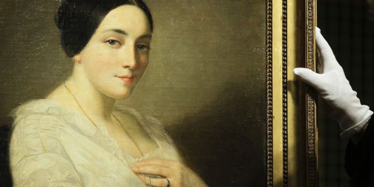 La pintura 'Retrato de una joven sentada' de Thomas Couture se coloca en un caballete durante una ceremonia de restitución a los herederos del político judío francés Georges Mandel en Berlín el 8 de enero de 2019. (AP Photo / Markus Schreiber)