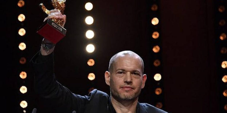 El director israelí, Nadav Lapid, celebra con su oso de oro la mejor película para 'Sinónimos' durante la ceremonia de entrega de premios del 69º festival de cine de la Berlinale el 16 de febrero de 2019 en Berlín. (John MACDOUGALL / AFP)