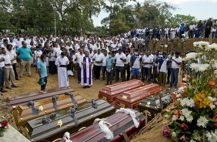 Un sacerdote realiza un entierro masivo para las víctimas de la explosión de la bomba del domingo de Pascua en Negombo, Sri Lanka, el 24 de abril de 2019. (Foto AP / Gemunu Amarasinghe)