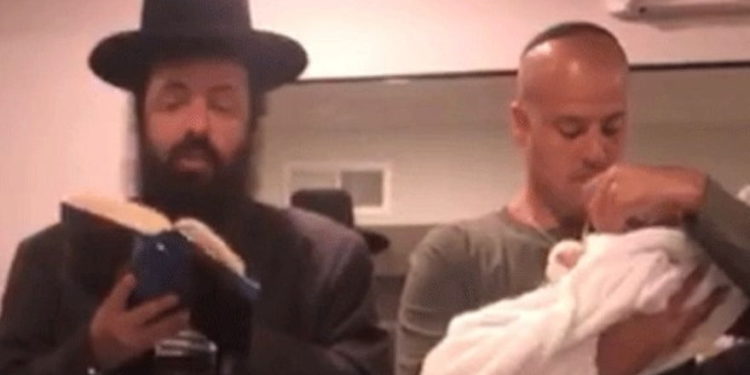 Israel Kostan cargando a su hijo (Canal 13)