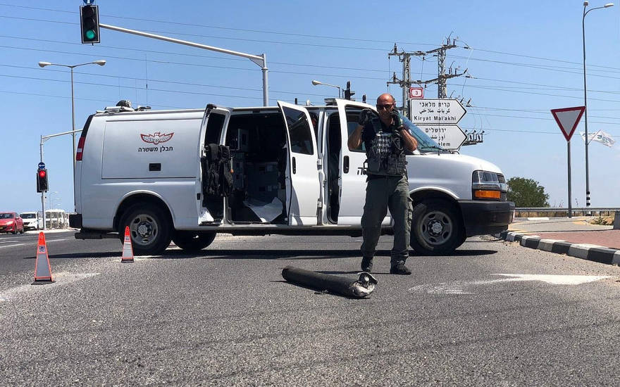 Se ve un zapador policial cerca de un cohete que golpeó una carretera principal cerca de Ashkelon (Policía de Israel)