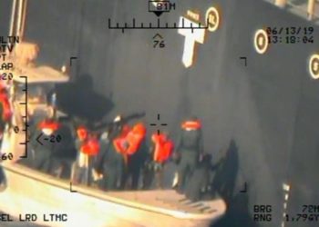 Esta imagen, publicada por el Departamento de Defensa de los EE. UU. El lunes 17 de junio de 2019 y tomada de un helicóptero de la Armada de los EE. UU., Muestra lo que la Armada dice que son miembros del Cuerpo de la Guardia Revolucionaria Islámica, que están retirando una mina de laca sin explotar del M / T Kokuka. Valiente. (Departamento de Defensa de los Estados Unidos a través de AP)