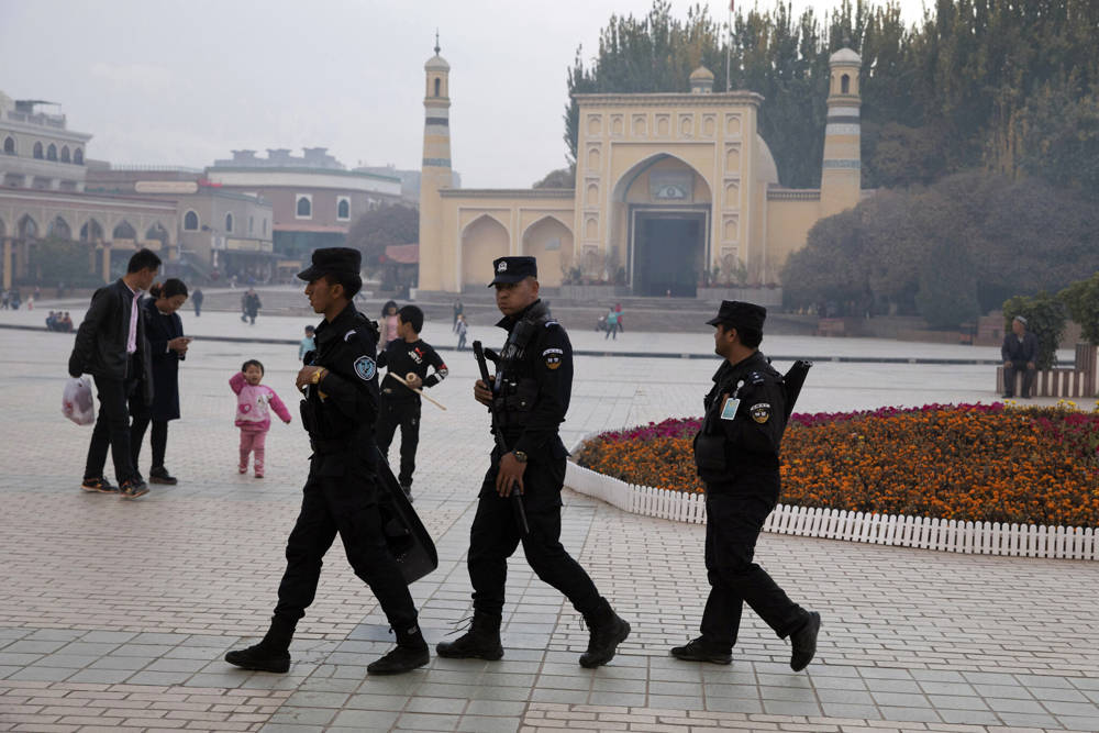En esta foto de archivo del 4 de noviembre de 2017, el personal de seguridad uigur patrulla cerca de la mezquita Id Kah en Kashgar, en la región occidental de Xinjiang, China. Documentos clasificados, filtrados a un consorcio de organizaciones de noticias, presentan la estrategia deliberada del gobierno chino para encerrar a las minorías étnicas para reconectar sus pensamientos e incluso el idioma que hablan. (Foto AP / Archivo)
