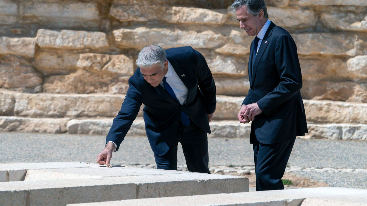 Después de reunirse para la Cumbre del Néguev, el ministro de Asuntos Exteriores, Yair Lapid, y el secretario de Estado de EE. UU., Antony Blinken, colocan piedras en señal de respeto en la tumba de David Ben Gurion, mientras visitan el Parque Nacional David Ben Gurion, el 28 de marzo de 2022, en Sde Boker, sur de Israel. (AP Photo/Jacquelyn Martin, Pool)