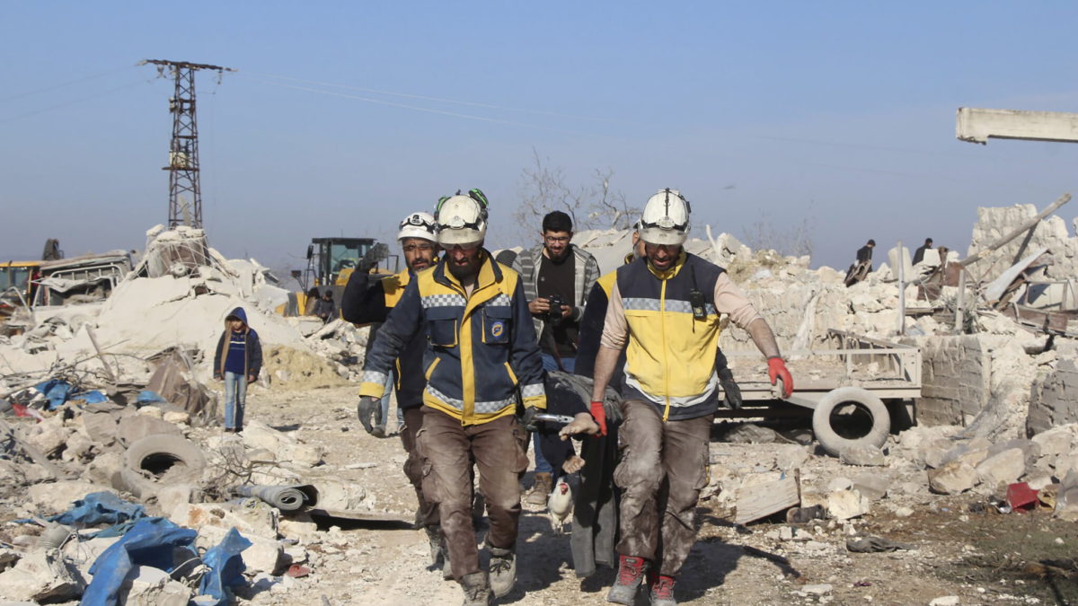 En esta foto proporcionada por los Cascos Blancos de la Defensa Civil Siria, que ha sido autentificada con base en su contenido y a otros informes de AP, trabajadores de la defensa civil de los Cascos Blancos sirios llevan a una víctima de las casas destruidas por los ataques aéreos rusos, en la aldea de Maaret Musreen, en la provincia de Idlib, Siria, el 5 de marzo de 2020. (Cascos Blancos de la Defensa Civil Siria vía AP)