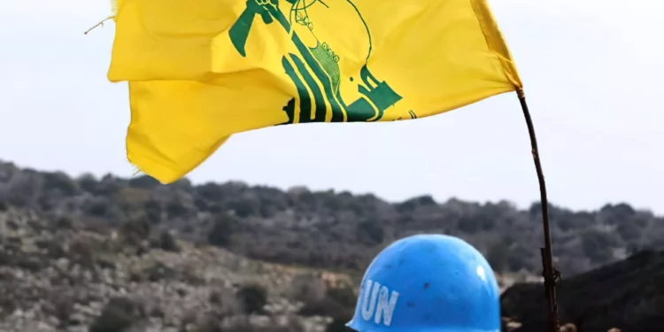 Una fotografía tomada desde la aldea sur de Líbano, Meiss al-Jabal, el 16 de diciembre de 2018, muestra a un soldado de las Fuerzas Provisionales de las Naciones Unidas en el Líbano (UNIFIL) que vigila la frontera entre el Líbano e Israel. A su derecha hay una bandera del grupo terrorista chií libanés Hezbolá. (Mahmoud Zayyat / AFP)