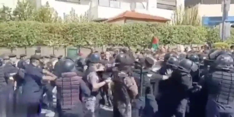 Jordanian security forces disperse the crowd of thousands of protesters trying to storm the Israeli embassy in Amman, Jordan in protest of the war in Gaza on October 18, 2023. (Screen capture/X)