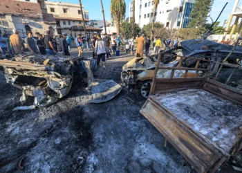 People search through debris outside the site of the Ahli Arab hospital in central Gaza on October 18, 2023 in the aftermath of a blast there. (Mahmud Hams/AFP)