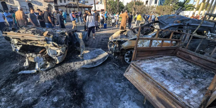 People search through debris outside the site of the Ahli Arab hospital in central Gaza on October 18, 2023 in the aftermath of a blast there. (Mahmud Hams/AFP)