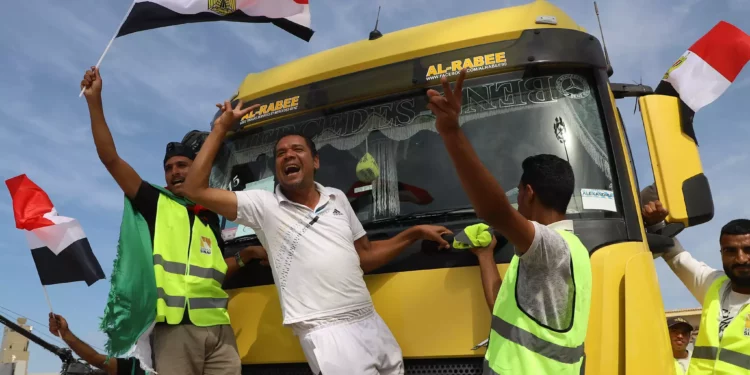 Egyptian aid workers celebrate as an aid truck crosses back into Egypt through the Rafah border crossing with the Gaza Strip on October 21, 2023. (Kerolos Salah/AFP)
Egyptian aid workers celebrate as an aid truck crosses back into Egypt through the Rafah border crossing with the Gaza Strip on October 21, 2023. (Kerolos Salah/AFP)