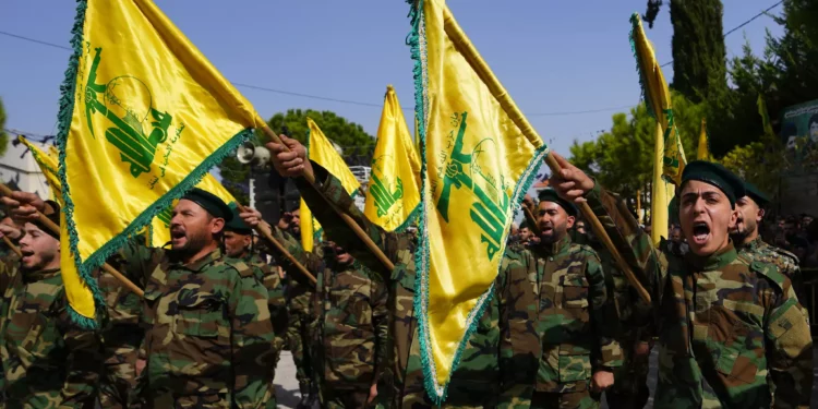 Combatientes de Hezbolá gritan consignas, mientras asisten al cortejo fúnebre del combatiente de Hezbolá, Bilal Nemr Rmeiti, durante su cortejo fúnebre en el pueblo de Majadel, sur del Líbano, 22 de octubre de 2023. (AP Photo/Hassan Ammar)