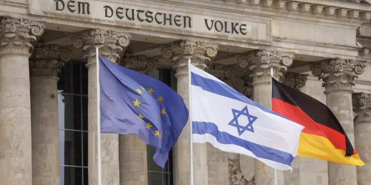 La bandera israelí ondea en medio de la europea (I) y la alemana frente al edificio del Reichstag que alberga el Bundestag, la cámara baja del Parlamento alemán en Berlín, mientras la canciller alemana pronuncia un discurso sobre el conflicto Israel-Hamás durante una sesión del Bundestag el 12 de octubre de 2023. (Odd ANDERSEN / AFP)