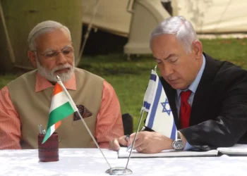 PRIME MINISTER of India Narendra Modi looks on during his 2017 visit to Israel as Prime Minister Benjamin Netanyahu signs a document of cooperation. (photo credit: MARC ISRAEL SELLEM/THE JERUSALEM POST)