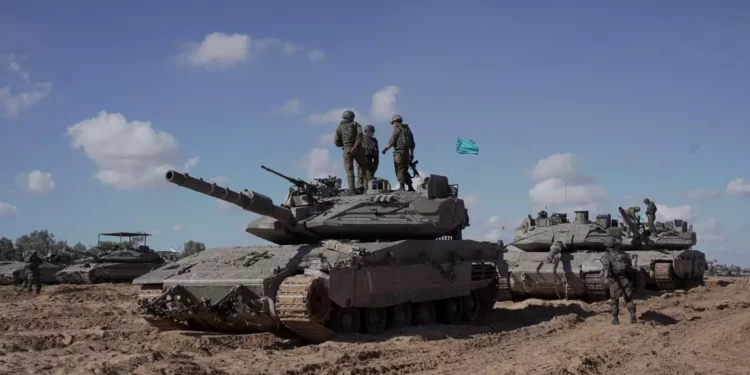 FDI soldiers under the Givati Brigade stand atop a tank in eastern Rafah in the southern Gaza Strip, in a handout picture released on May 10, 2024. (Israel Defense Forces)