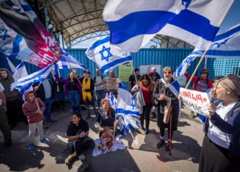 Activists protest outside the UNRWA office in Jerusalem on March 20, 2024. (Yonatan Sindel/Flash90)