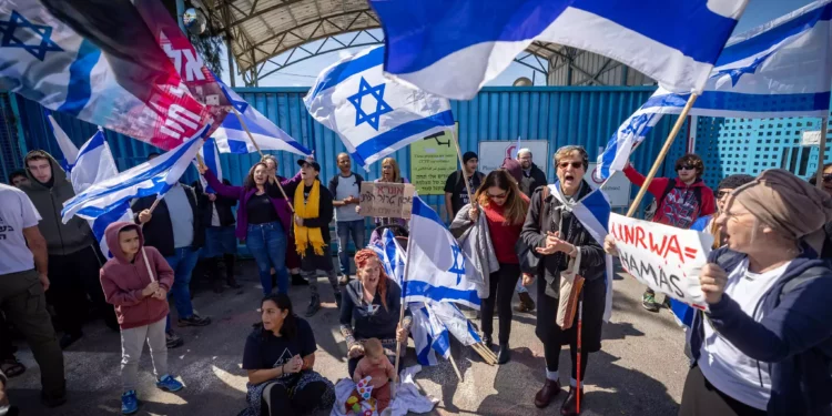 Activists protest outside the UNRWA office in Jerusalem on March 20, 2024. (Yonatan Sindel/Flash90)