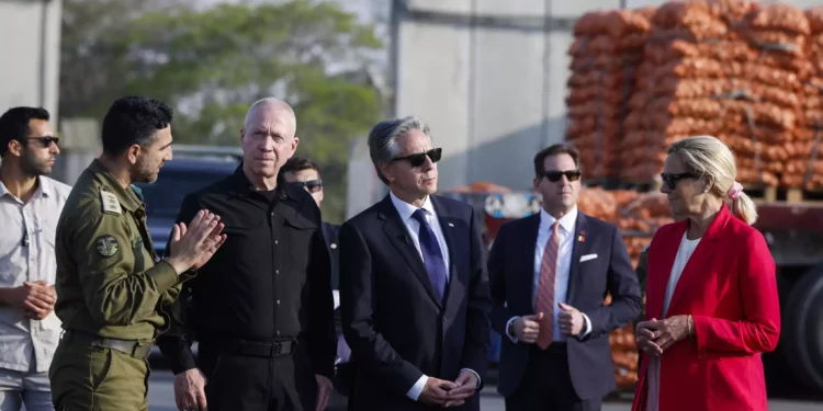 US Secretary of State, Antony Blinken, third right, stands between Defense Minister Yoav Gallant, third left, and UN Senior Humanitarian and Reconstruction Coordinator for Gaza, Sigrid Kaag, right, at the Kerem Shalom border crossing in Kerem Shalom, Israel, May 1, 2024. (Evelyn Hockstein/Pool Photo via AP)