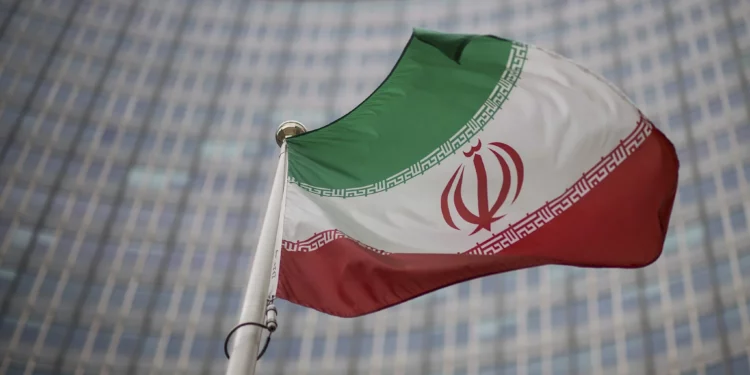 File - A national flag of Iran waves in front of the building of the International Atomic Energy Agency, IAEA, in Vienna, Austria, Dec. 17, 2021 (AP Photo/Michael Gruber, File)