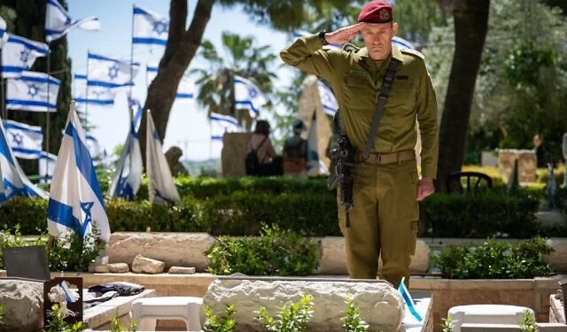 FDI Chief of Staff Lt. Gen. Herzi Halevi salutes at a military grave in an undated photo released by the military for publication on October 27, 2024 (Israel Defense Forces)