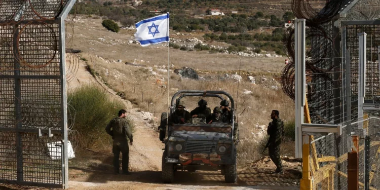 Un vehículo militar israelí cruza la valla, regresando de la zona de amortiguamiento con Siria, cerca de la aldea drusa de Majdal Shams en los Altos del Golán, el 10 de diciembre de 2024. (Foto de Jalaa MAREY / AFP)