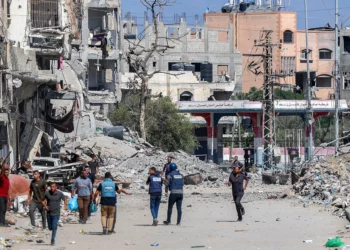 Periodistas filman frente a edificios destruidos en Jabaliya, en el norte de la Franja de Gaza, el 9 de octubre de 2024. (Omar Al-Qattaa/AFP)