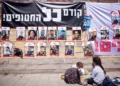 Afuera del Ministerio de Defensa en Tel Aviv se ven carteles de israelíes tomados como rehenes en Gaza, bajo una pancarta que dice: “¡Primero, los rehenes!”, el 9 de marzo de 2025. (Miriam Alster/FLASH90)