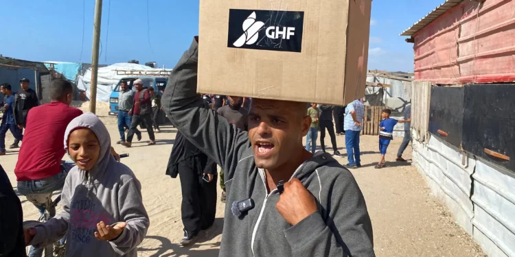 Palestinos abren una caja con alimentos y paquetes de ayuda humanitaria entregados por la Fundación Humanitaria de Gaza, una organización respaldada por Estados Unidos y aprobada por Israel, en Rafah, al sur de la Franja de Gaza, el 27 de mayo de 2025. (Foto AP/Abdel Kareem Hana)