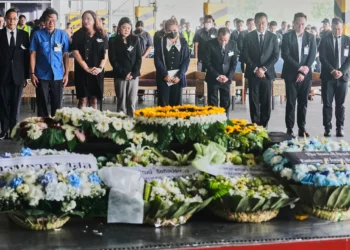 Narissara Chantasang (quinta desde la izquierda), esposa de Nattapong Pinta, un trabajador tailandés que fue tomado como rehén y asesinado por terroristas en Gaza, asiste a un servicio conmemorativo silencioso cerca del ataúd que contiene su cuerpo en el Aeropuerto Internacional de Suvarnabhumi, en la provincia de Samut Prakarn, Tailandia, el 11 de junio de 2025. (Foto AP/Sakchai Lalit)