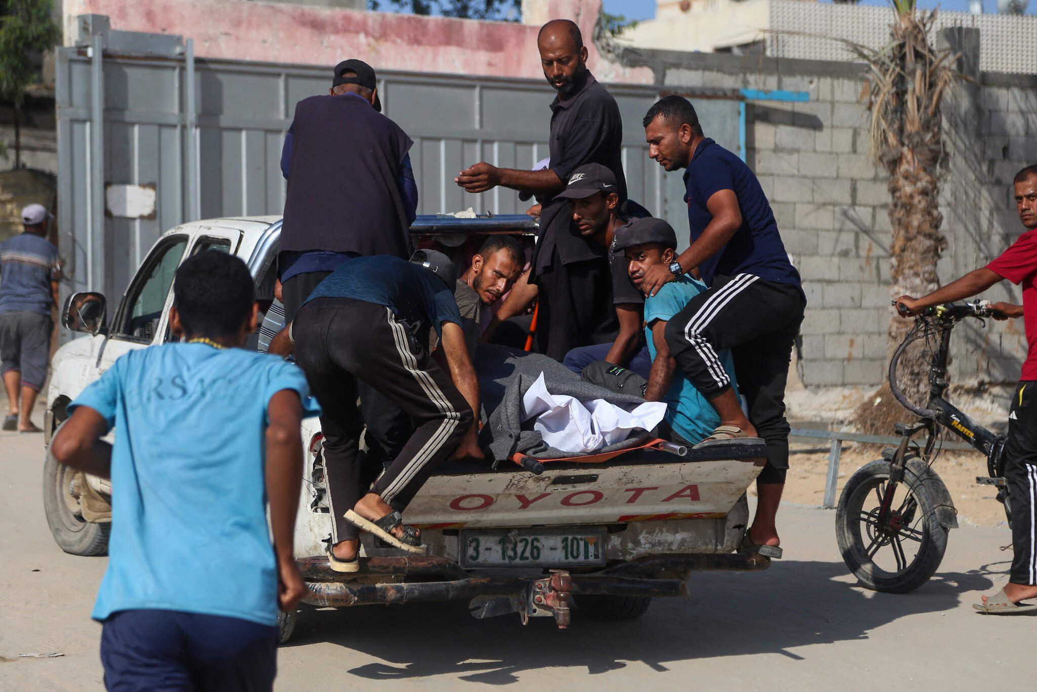 Gazatíes transportan un cuerpo tras los enfrentamientos en el hospital Nasser en Jan Yunis, en el sur de la Franja de Gaza, el 22 de julio de 2025. (AFP)